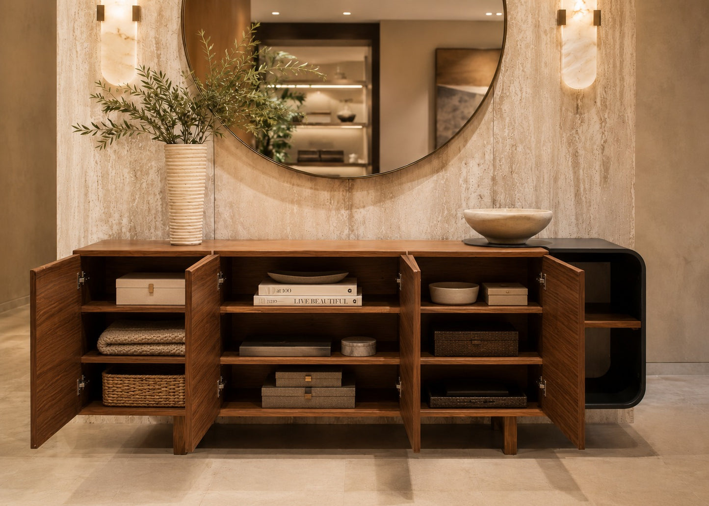 Wooden sideboard with open doors in a room with a large round mirror and decorative items.