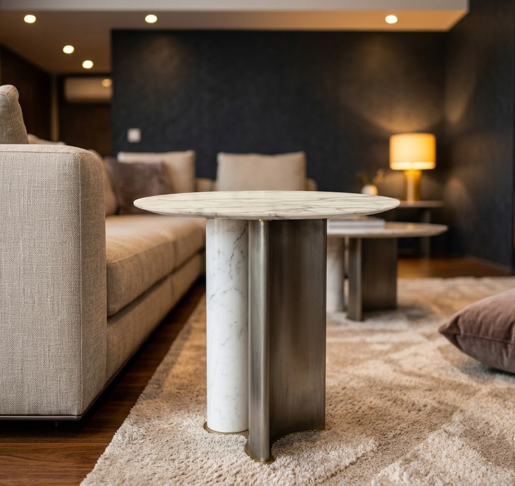 Modern living room with a marble and metal side table, sofa, and lamp.