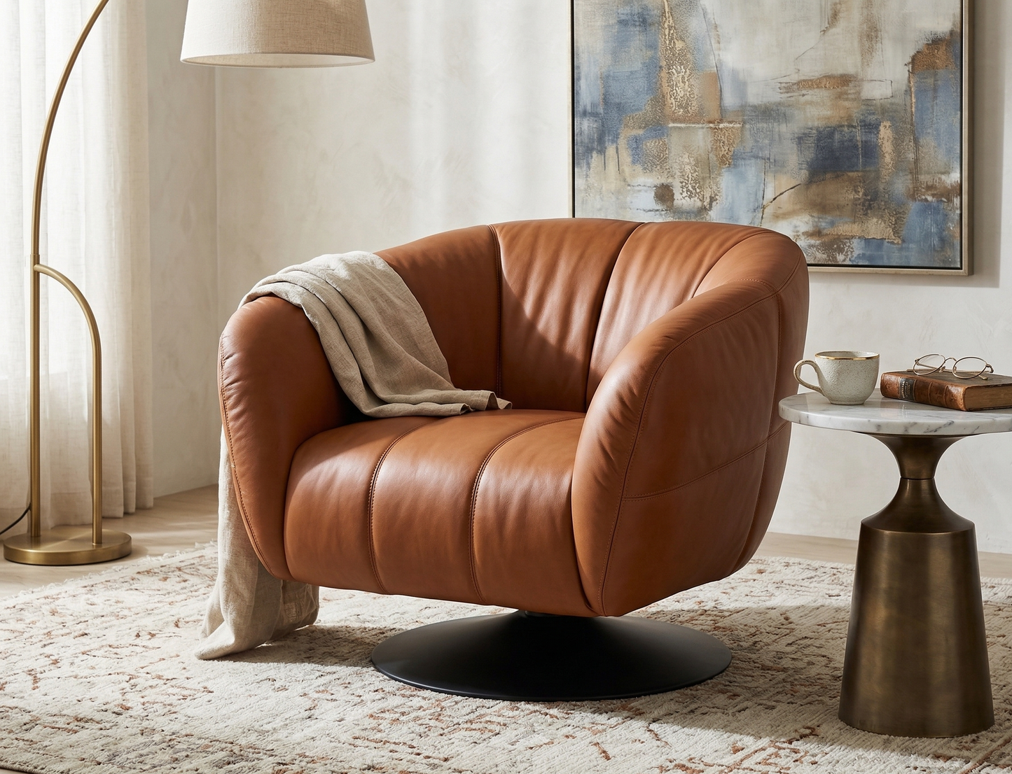 Brown leather armchair in a living room setting with a side table and abstract painting.