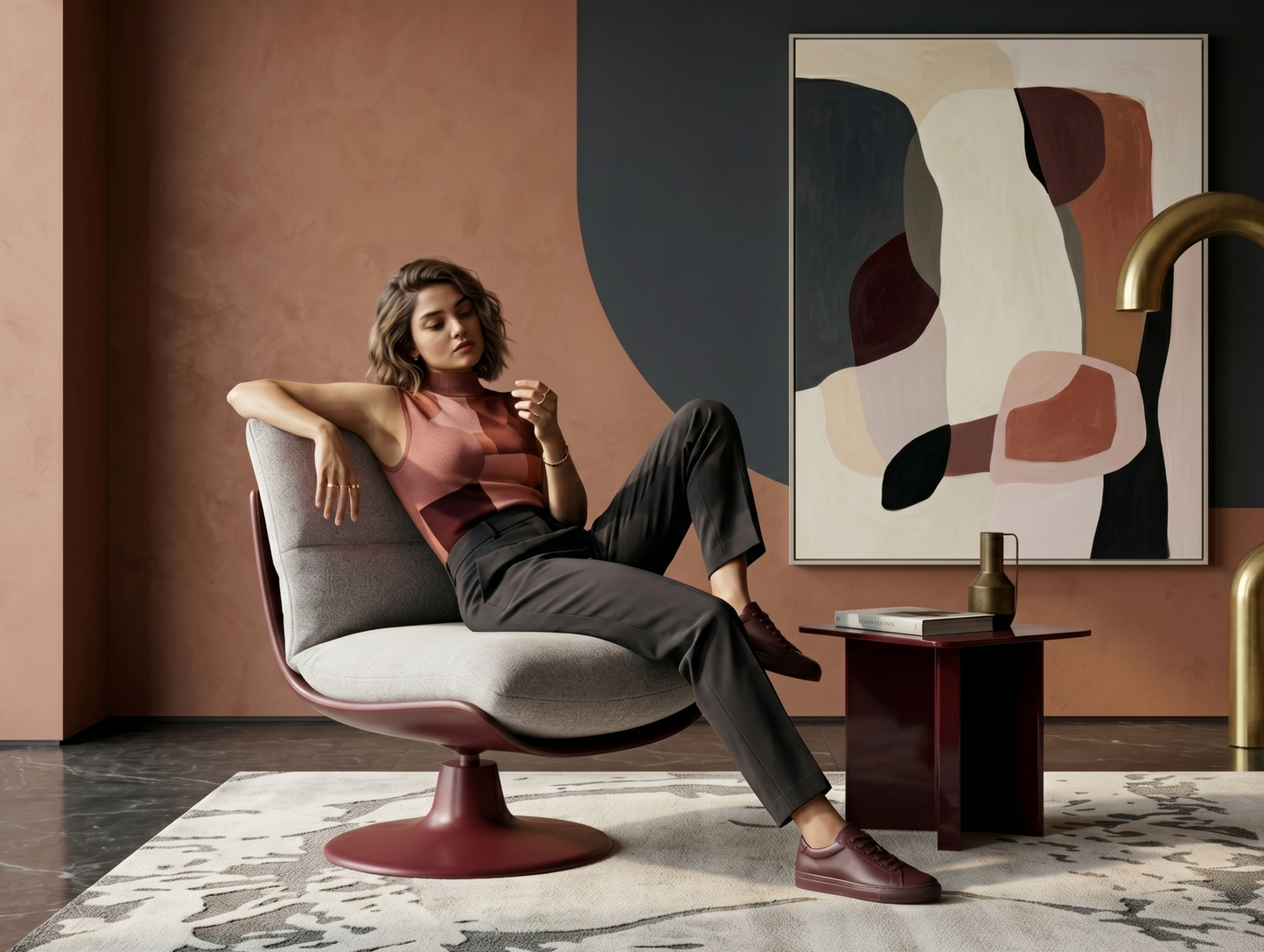Woman sitting in a modern chair in a stylish room with abstract art and decor.