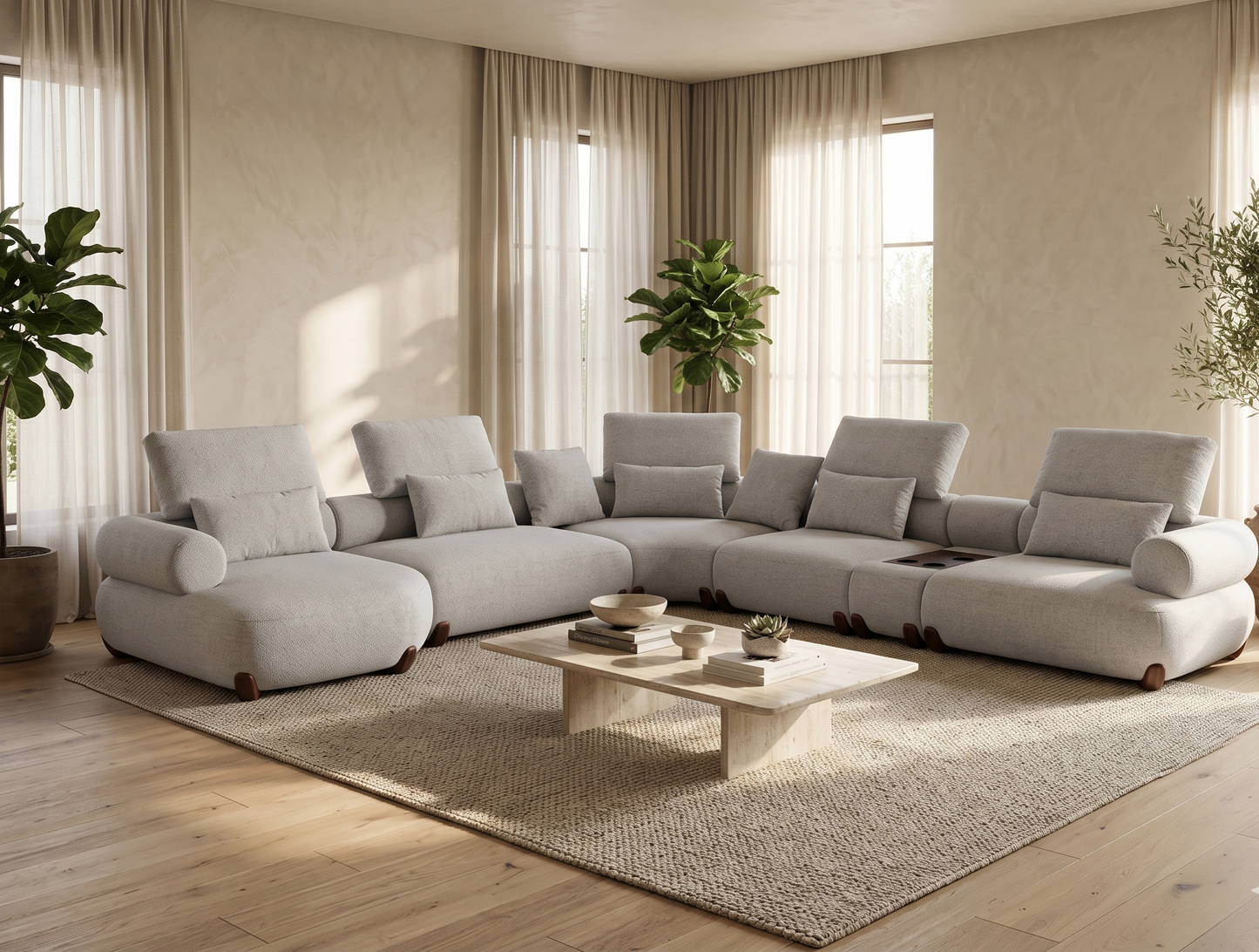 Modern living room with a large gray sectional sofa, coffee table, and decorative plants.