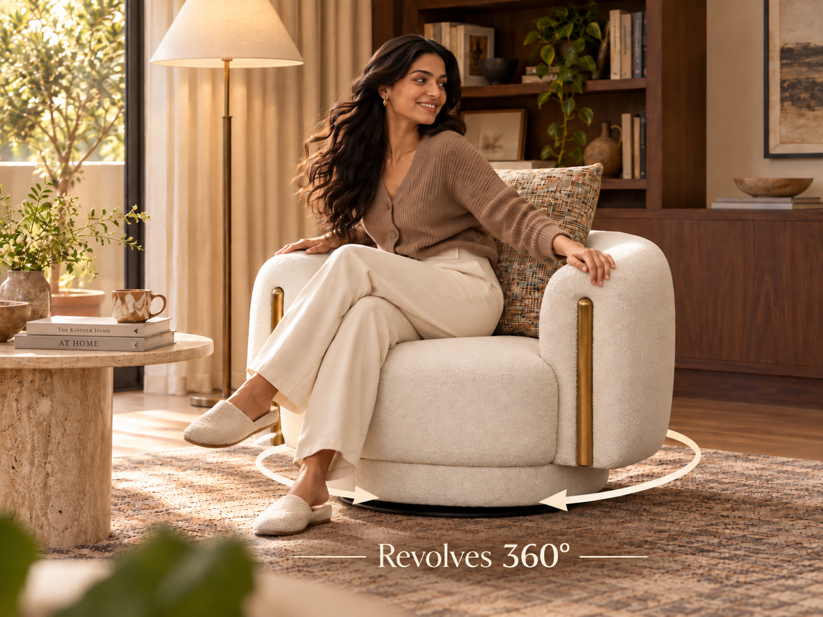 Bari Armchair with woman demonstrating the 360 degree swivel function in a warm home lounge