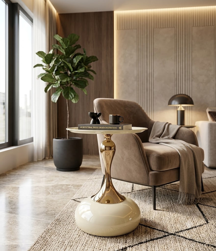 Modern living room with a gold side table, brown armchair, and decorative plant.
