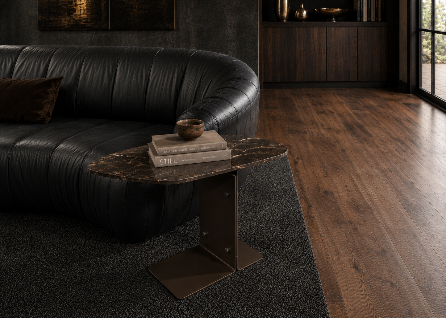 Modern living room with a black leather sofa and a wooden side table.