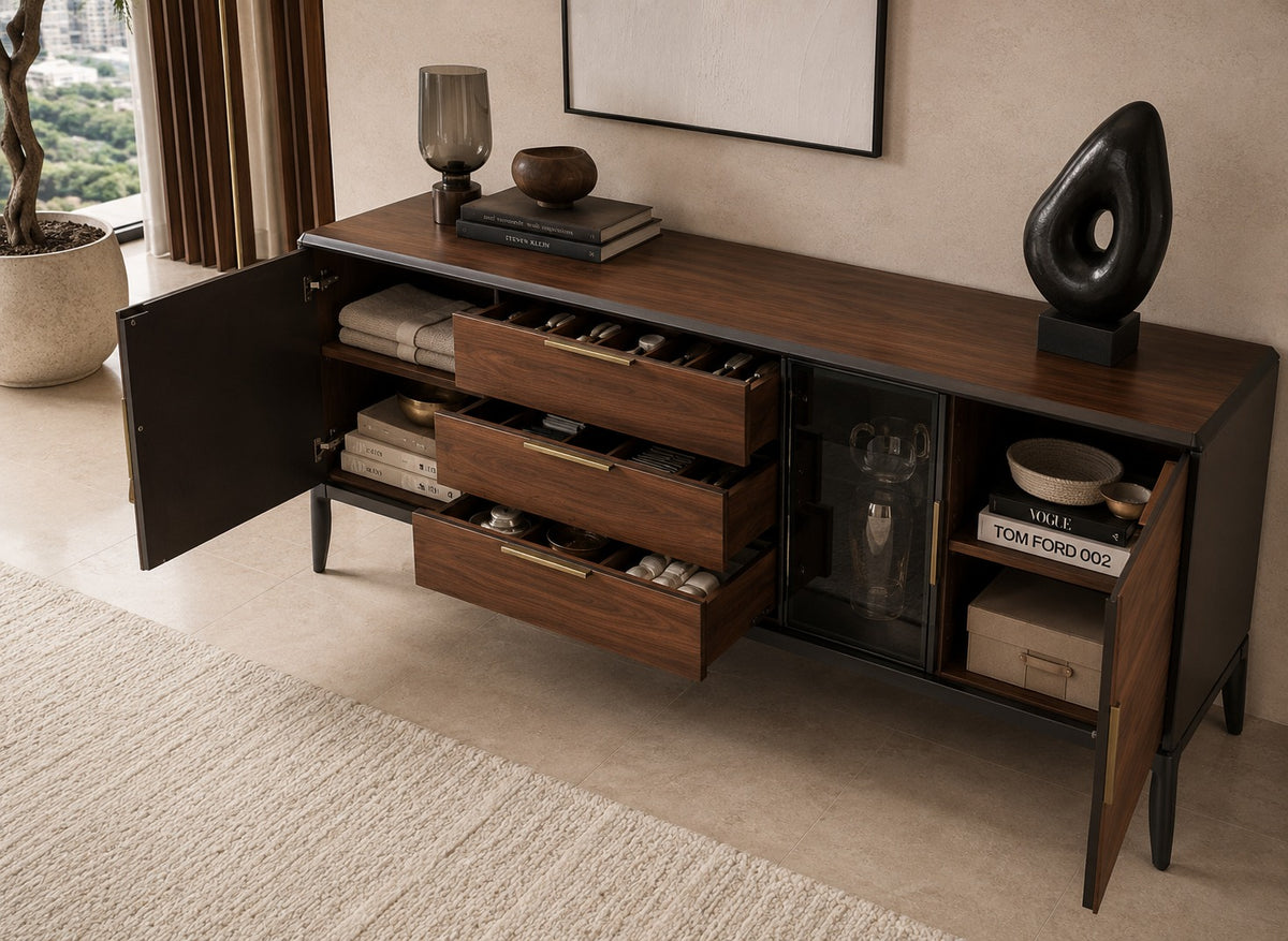 Wooden sideboard with open doors in a room with decor elements.