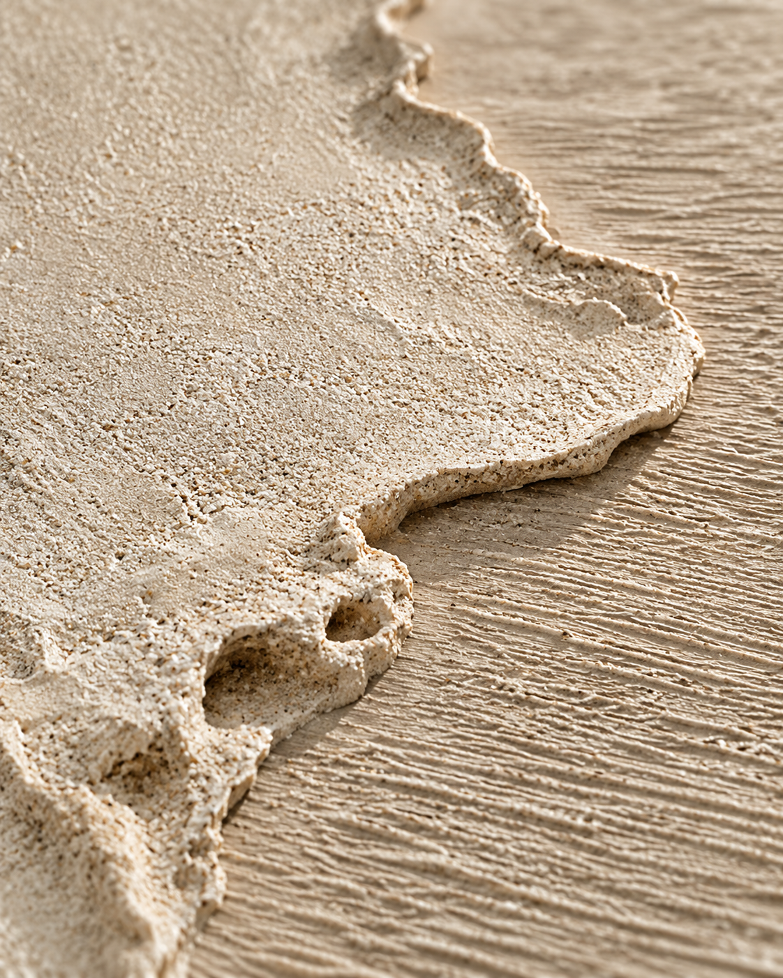 Sculptural sandstone artwork and tactile finishes in a contemporary interior