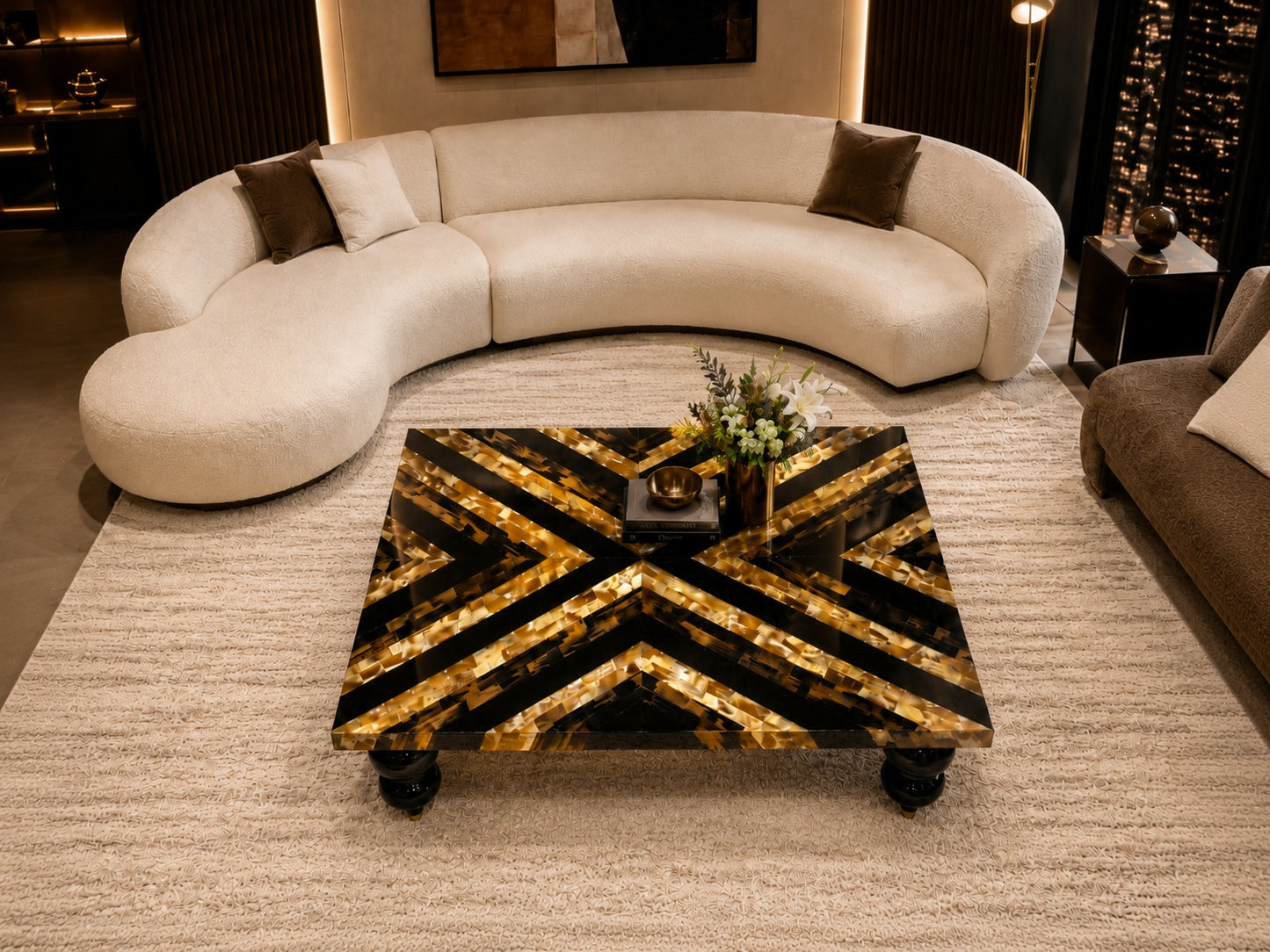 Modern living room with a curved beige sofa and decorative coffee table.