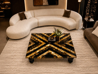 Modern living room with a curved beige sofa and decorative coffee table.