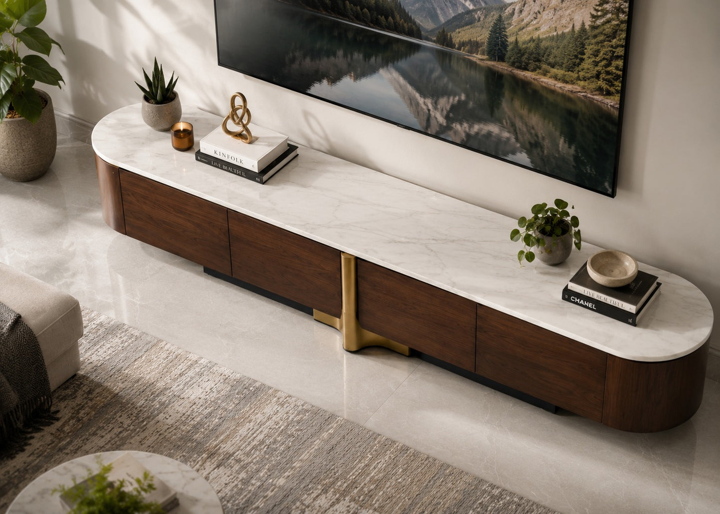A modern curved media console with a white marble-look top and dark wood drawers, styled in a living room setting with a TV, plants, and books.
