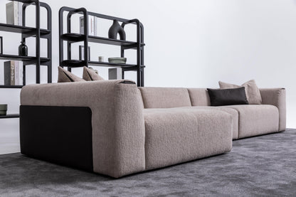 Soho luxury left chaise modular corner sofa viewed from rear three-quarter angle showing low profile and black contrasting side detailing
