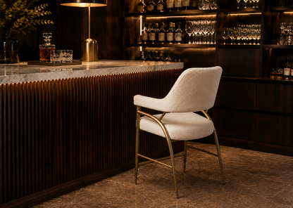 White chair with gold legs in a bar setting