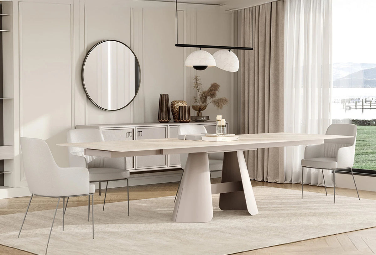 Sculptural extendable dining table with travertine-look surface and contemporary Italian design language