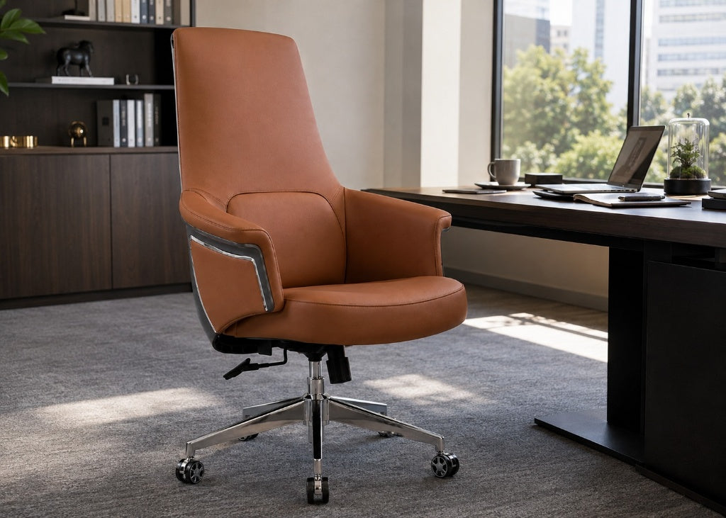 A modern high-back office chair upholstered in warm cognac brown leather with a chrome five-star base, positioned in a contemporary office setting next to a desk.