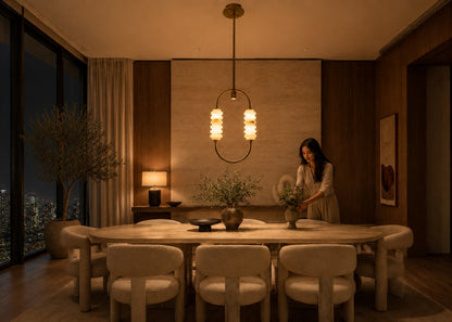 Woman arranging flowers in a modern dining room with a cityscape view.