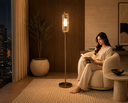 Woman reading a book in a cozy living room with a floor lamp and cityscape view.