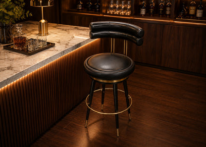 Bar stool in a dimly lit bar setting with wooden counter and bottles.