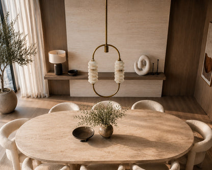 Dining room with wooden table and chairs, decorative elements, and a lamp.