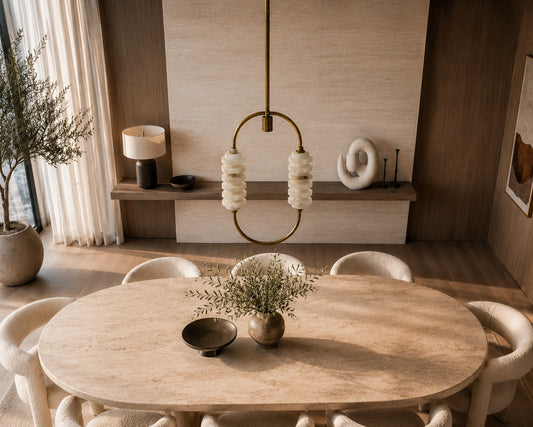 Dining room with wooden table and chairs, decorative elements, and a lamp.