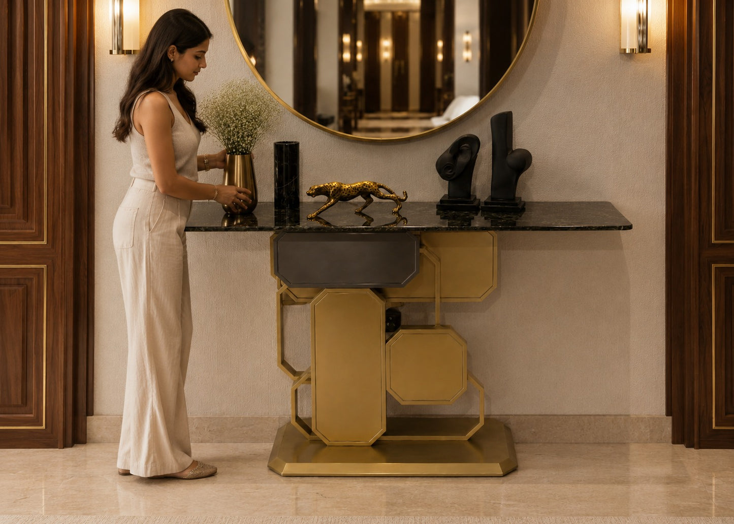 Woman arranging flowers on a decorative console table in an elegant interior setting.