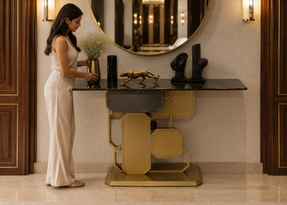 Woman arranging flowers on a decorative console table in an elegant interior setting.