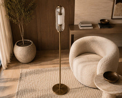 Modern interior with a textured armchair, standing lamp, and decorative items.