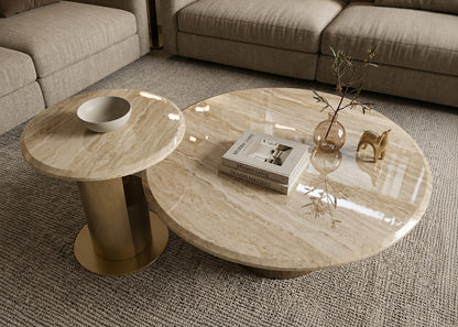Round marble coffee table with decorative items in a living room setting