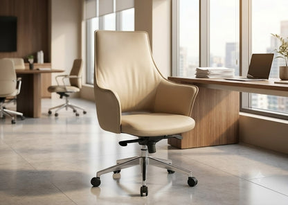 A modern beige leather office chair with a high back and chrome five-star base, positioned in a bright, contemporary office space with large windows.