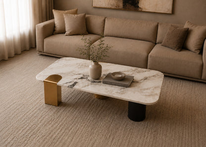 Modern living room with a beige sectional sofa and marble coffee table.