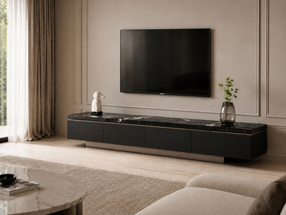 A modern black floating TV console with a polished marble top, styled in a minimalist living room with a wall-mounted flat-screen TV and neutral beige decor.