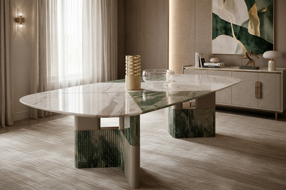 An elegant oval dining table with a polished white and green marble top and textured green-and-white pedestal bases, styled in a luxurious modern dining room.