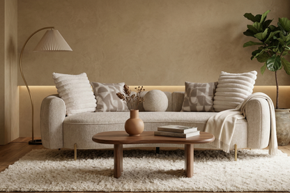 Cozy living room with a beige sofa, wooden coffee table, and decorative elements.
