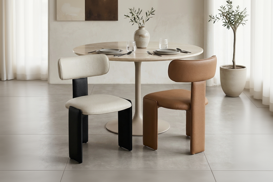 Dining area with a round table and two chairs in a modern interior setting.