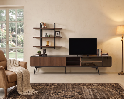 Modern living room with a television stand, shelves, and a lamp.
