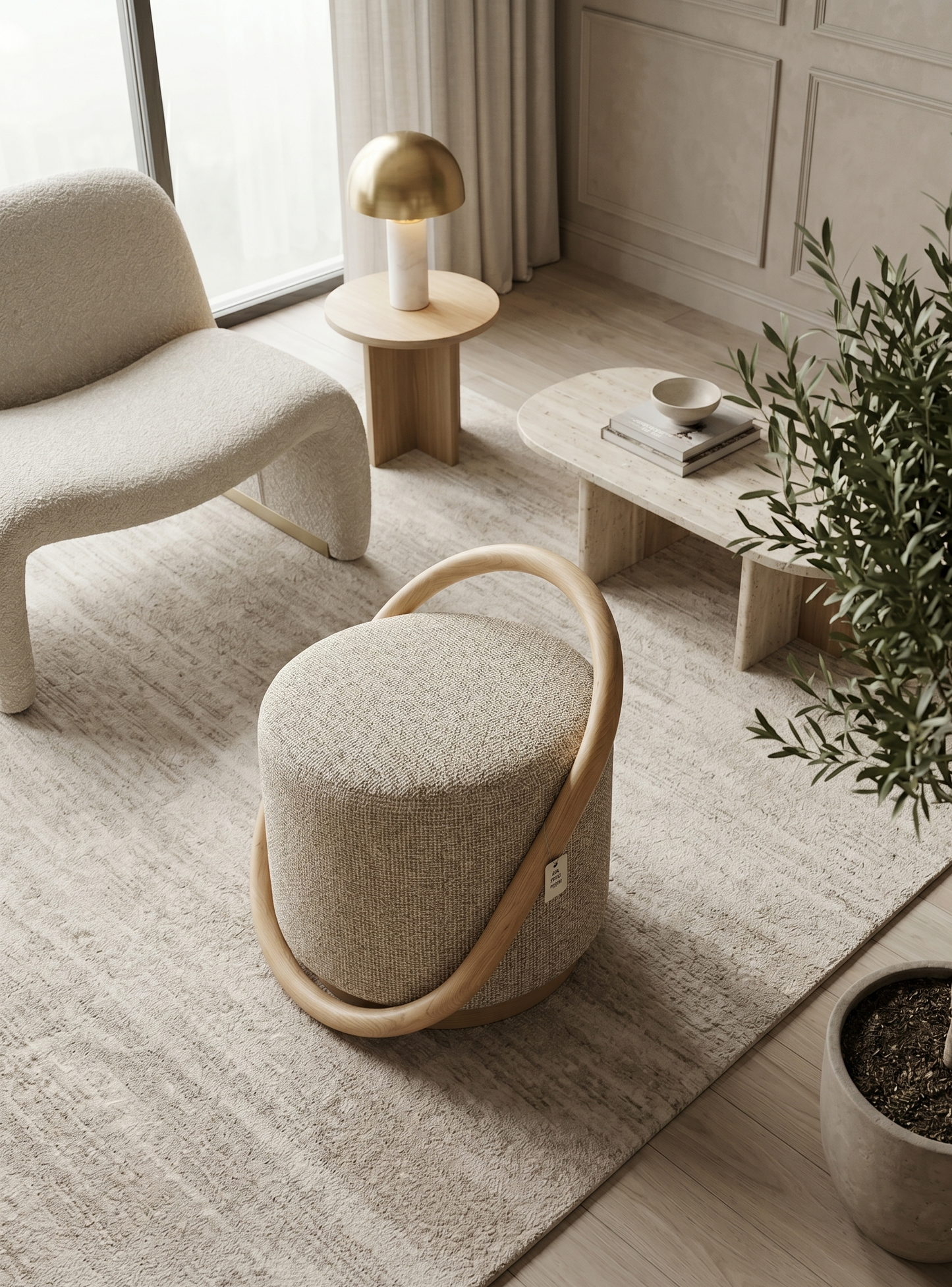 Modern living room with a beige armchair, ottoman, and a small table with a lamp.