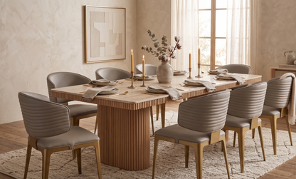 Dining room with a wooden table and chairs, candles, and a vase.