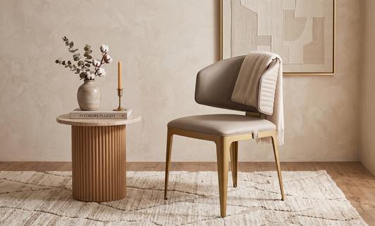 Modern chair with a wooden base and beige cushion in a room with a side table and decorative items.
