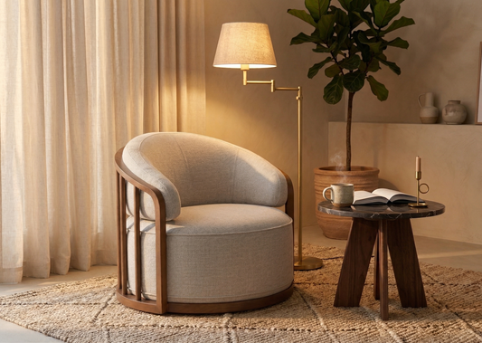 Cozy living room with a beige armchair, side table, and lamp.