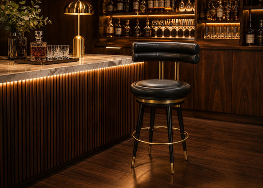 Bar stool in a dimly lit bar setting with wooden counter and shelves.