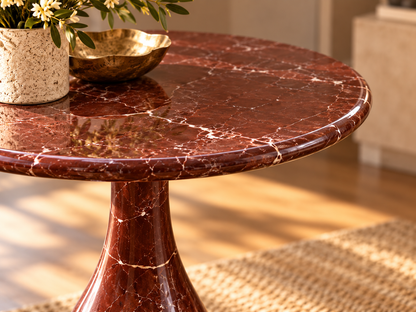 Close-up of Altera polished burgundy red marble top with delicate white veining and rounded edge