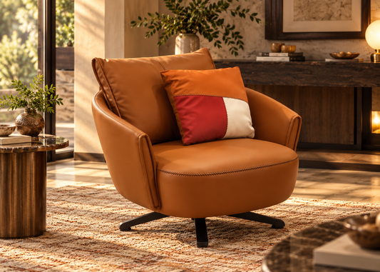 Aveline cognac leather armchair three-quarter front view with stitched arms and colour-block cushion
