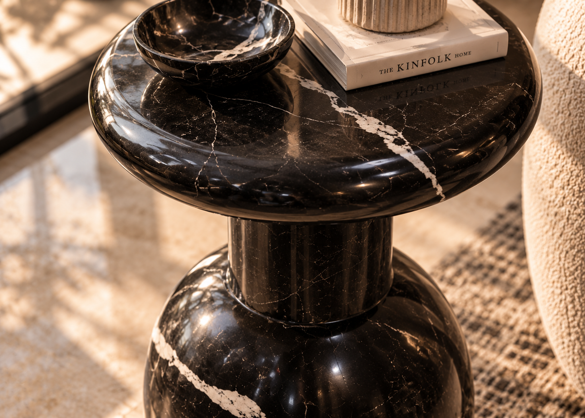 Close-up of Nero Vaso black marble-style round tabletop with gently rolled lip and intricate white veining, polished stone detail
