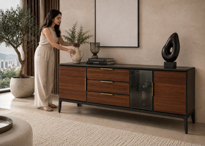 Woman arranging a vase on a wooden sideboard in a modern living room.