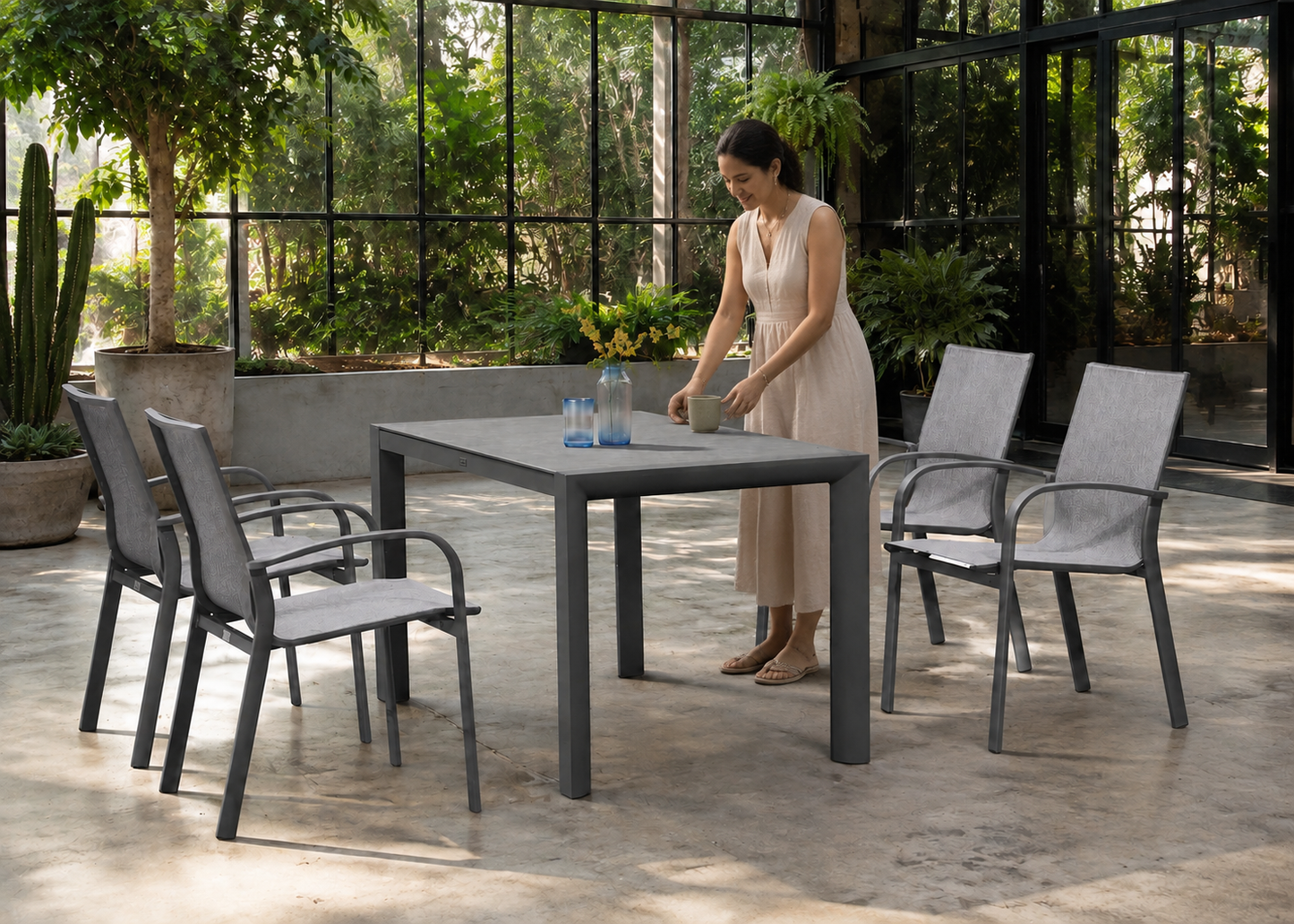 Bagota table in Bogotá Greenhouse Patio with Indian model – lifestyle view