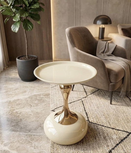 Modern side table with gold base and white top in a living room setting