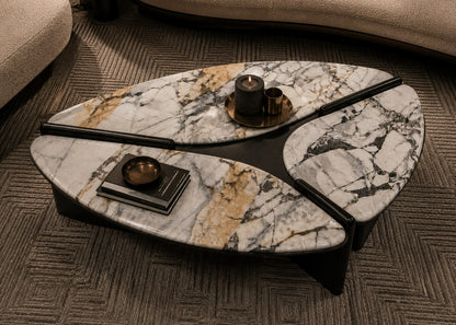 Marble-patterned coffee table with decorative items on a carpeted floor