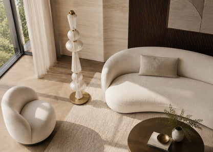 Modern living room with a beige sofa, armchair, and decorative floor lamp.