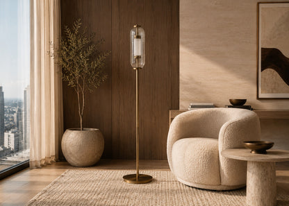 Modern living room with a beige armchair, floor lamp, and city view.