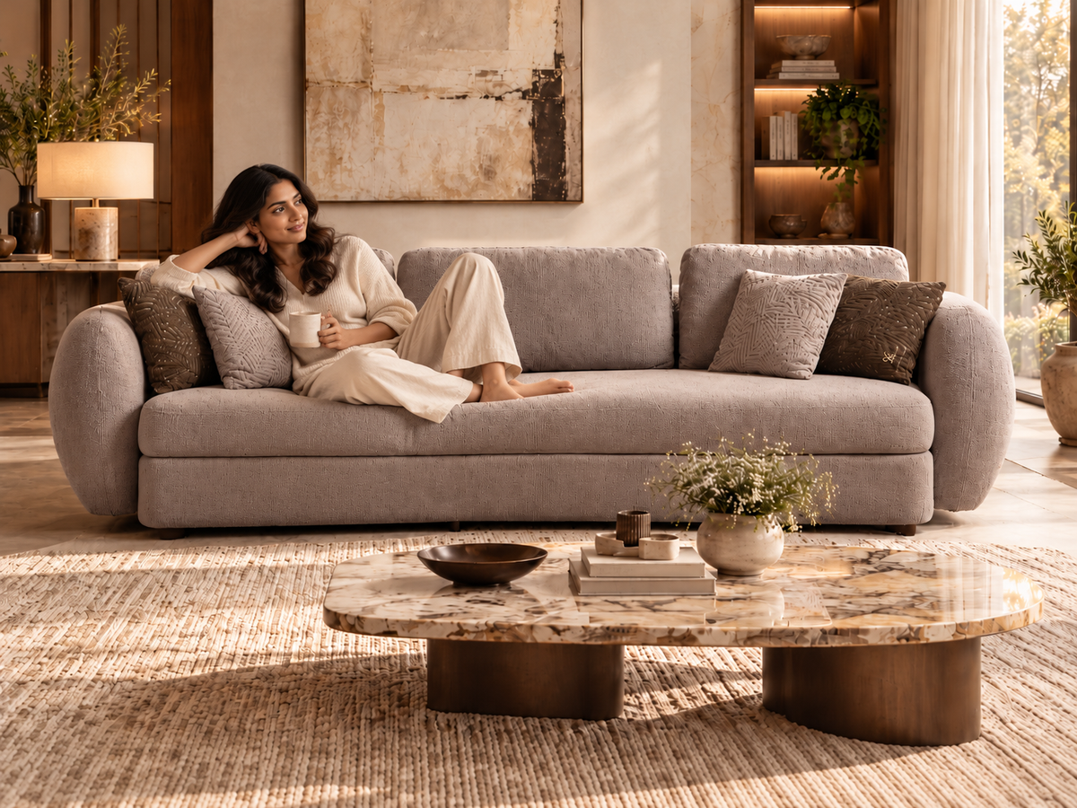 Luna three seater sofa with a woman relaxing naturally in a softly lit luxury room