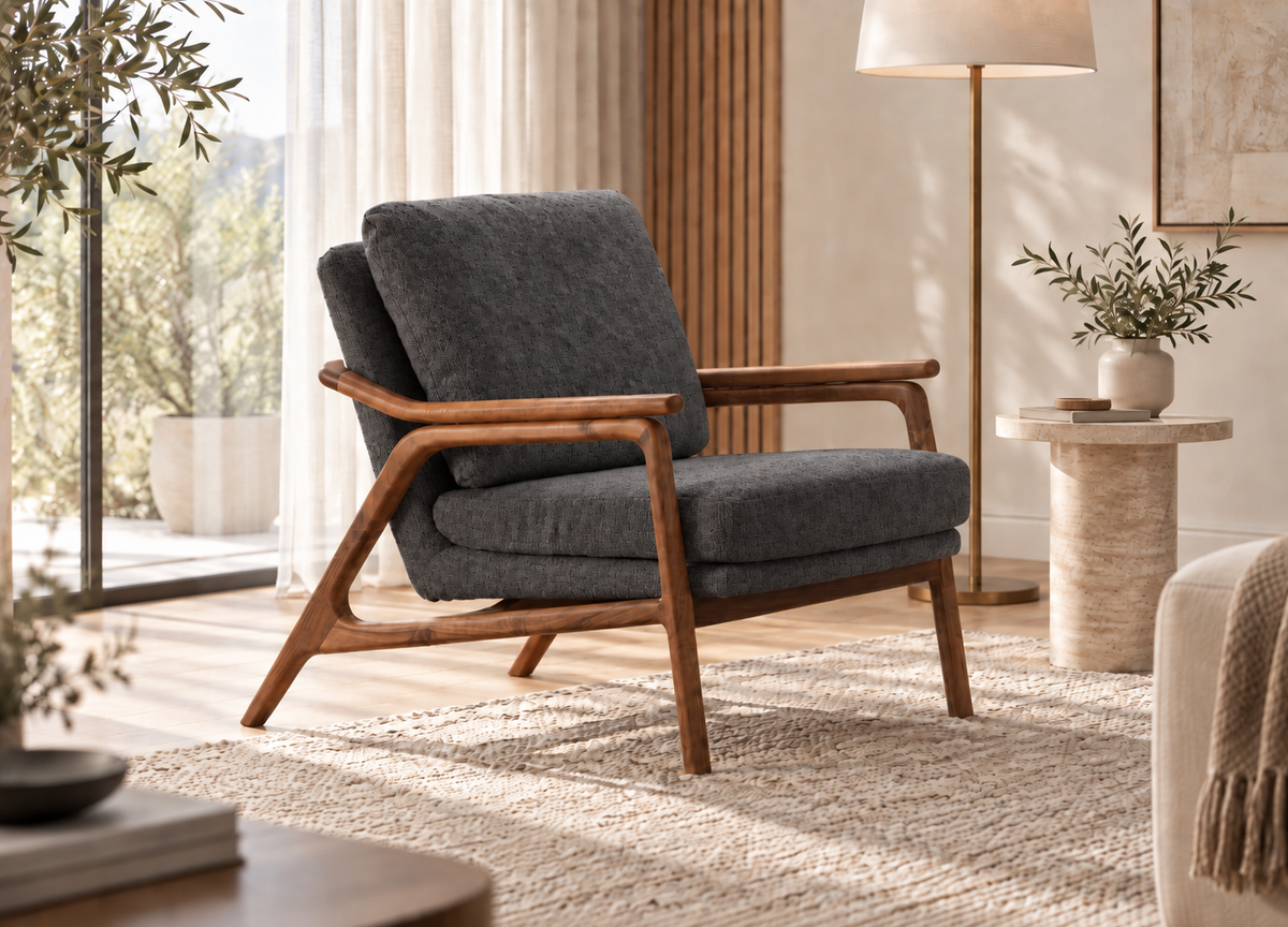 Ellipse Armchair in dark grey upholstery with sculptural walnut wood frame in a modern living room