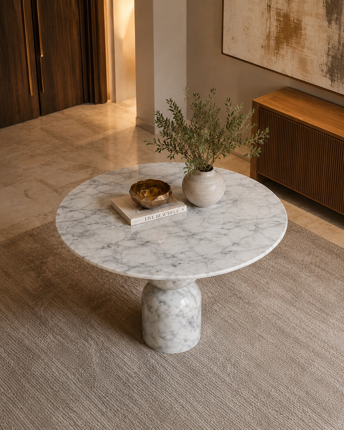 Marble coffee table with decorative items in a modern living room.